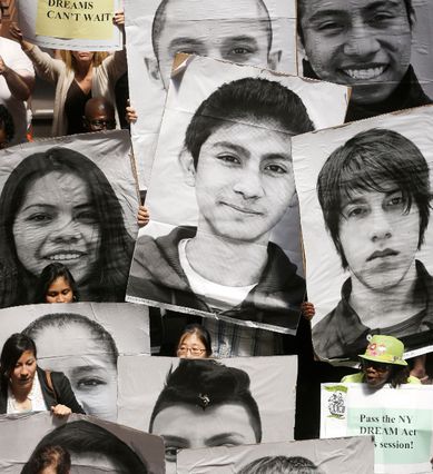 Supporters of the New York DREAM Act hold photos of undocumented students who are not eligible for college tuition assistance during a rally at the Capitol in Albany in 2013.